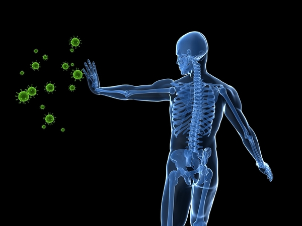 Skeletal anatomy of human body in blue with green virus particles approaching outstretched arm against black background