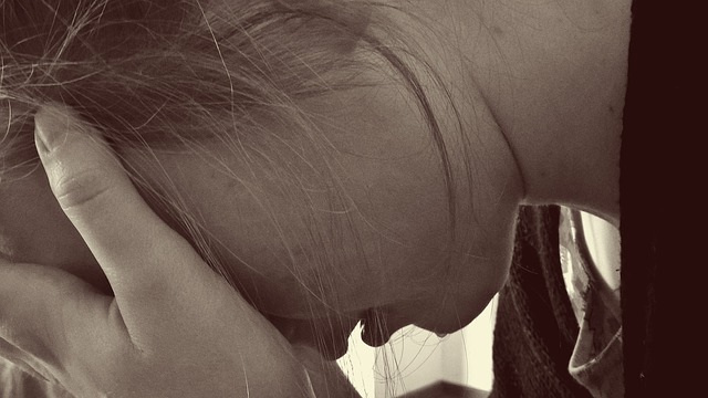 Woman's neck and shoulder area in profile, suggesting neck pain or discomfort