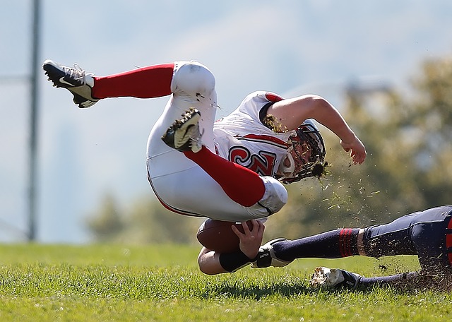 Baseball player diving horizontally toward base during game on grass field